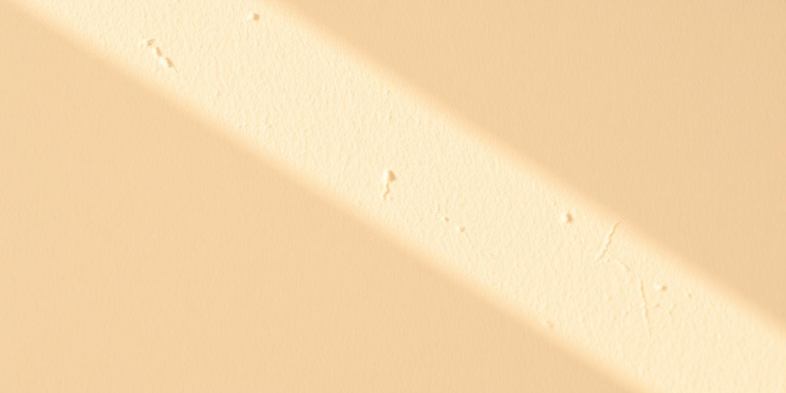 Macro detail of a finished drywall seam in warm sunlight